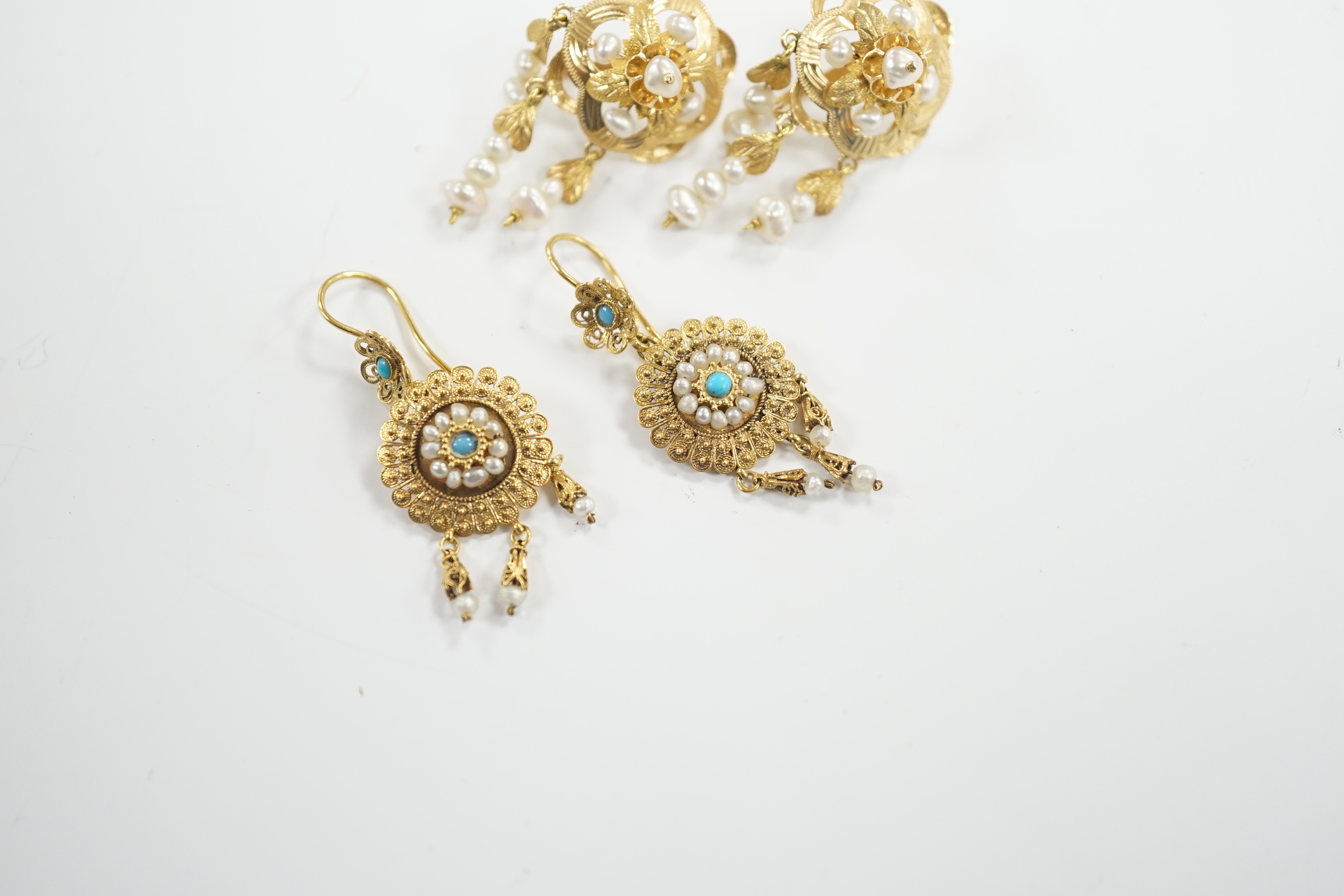 A pair of continental yellow metal and cultured pearl cluster set drop earrings, 36mm and a pair of yellow metal filigree, seed pearl and turquoise set drop earrings, gross weight 10.9 grams.